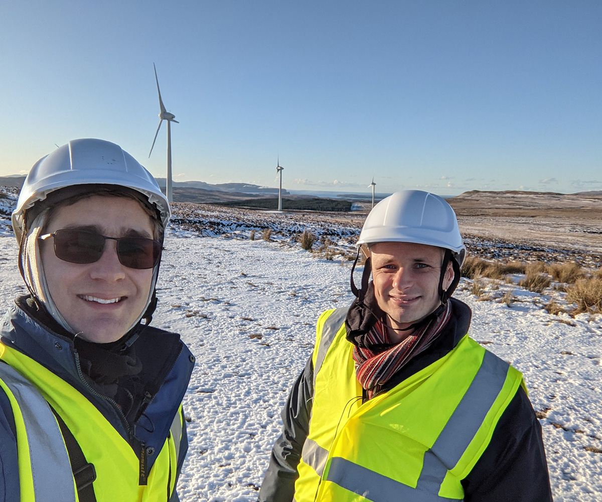 members of Perceptual Robotics team wearing PPE on snowy wind farm