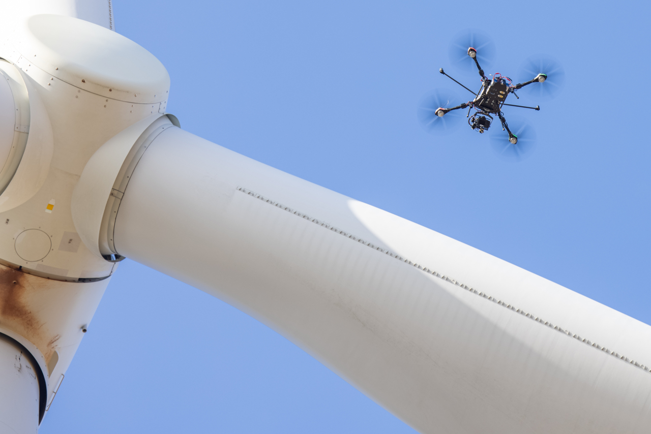 drone next to wind turbine