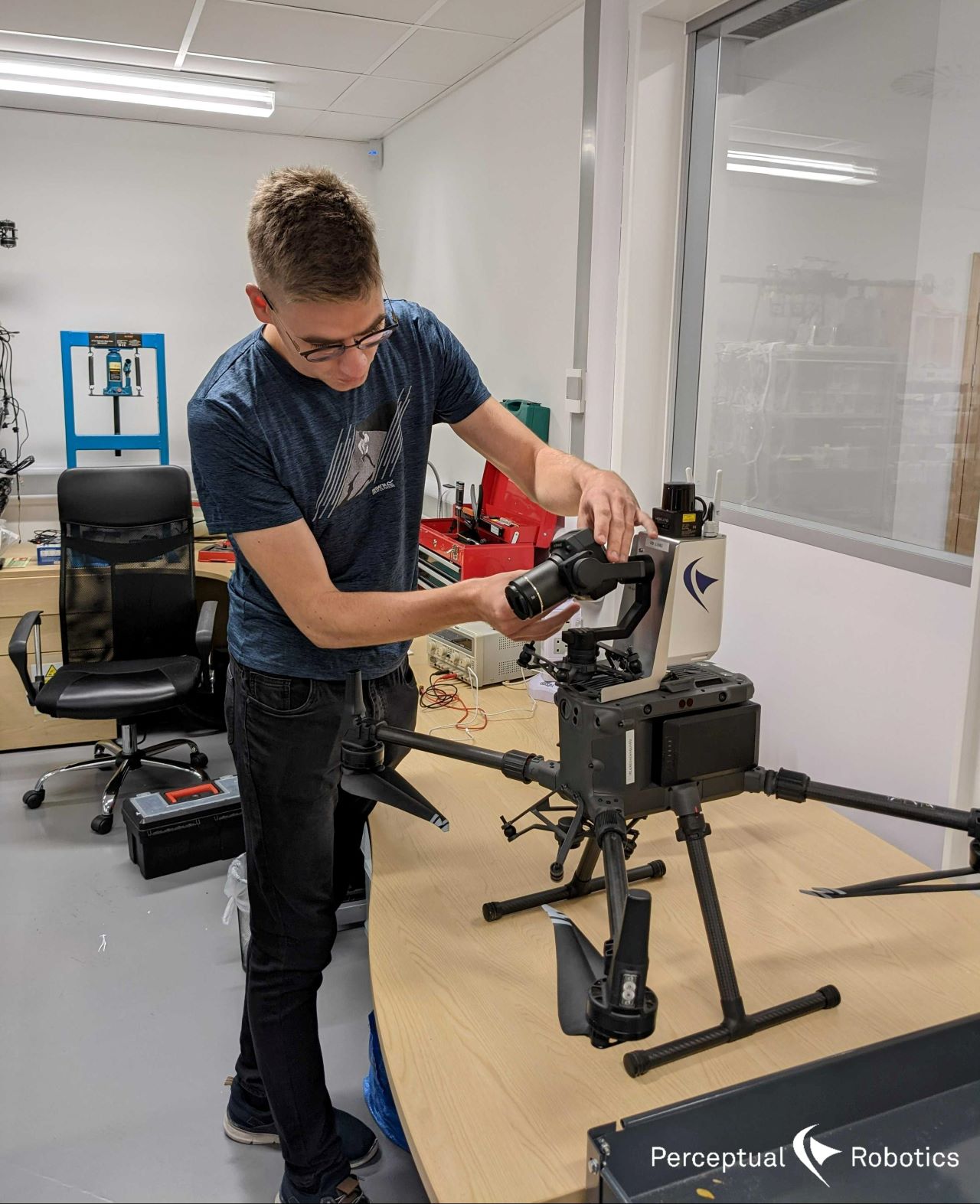 This is an image of Villius working on one of our drones in the office.