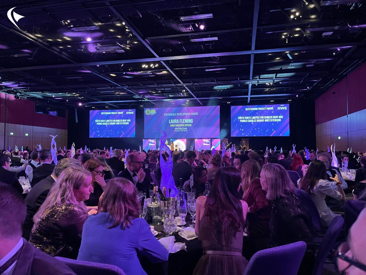 This is an image of the awards ceremony with people sitting at tables. 