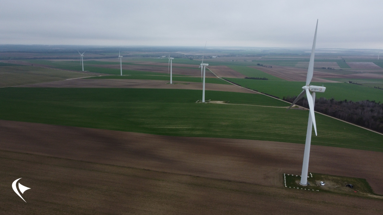 This is an image of a patch of land with various wind turbines.