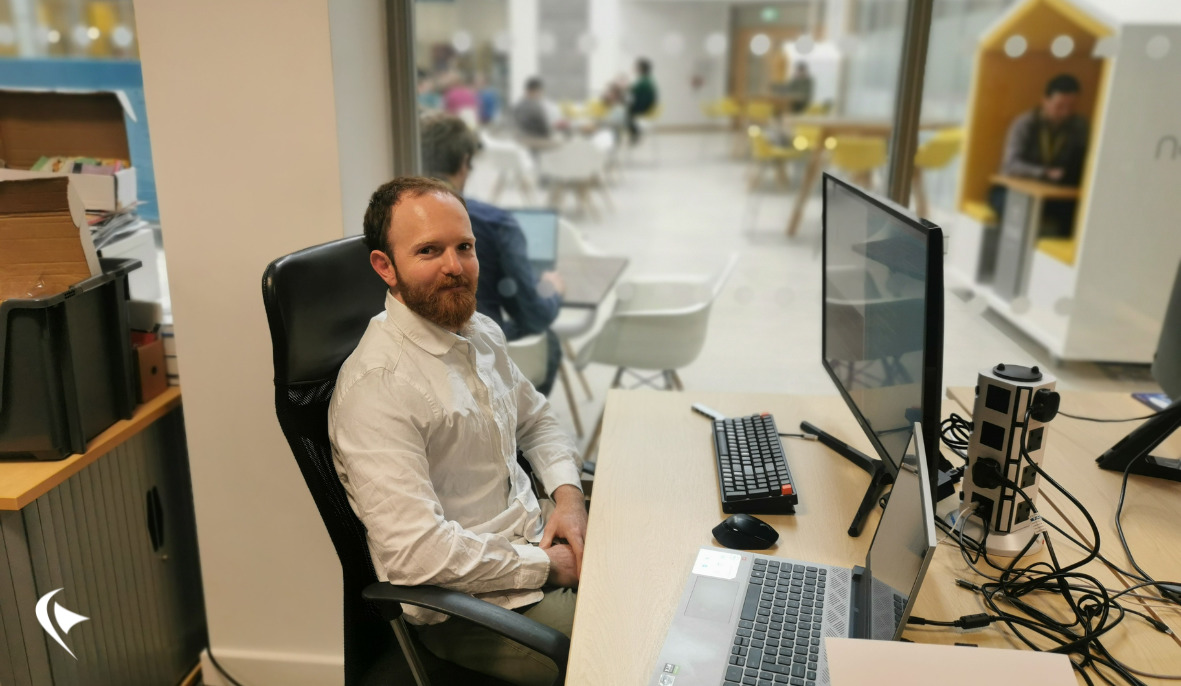 This is an image of Daniel at his desk in the office.